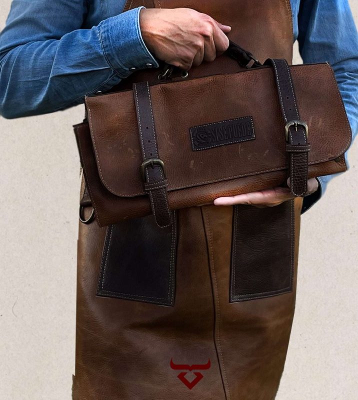 Chef holding a brown leather knife roll, perfect for carrying the essential knives for chefs in a professional kitchen.